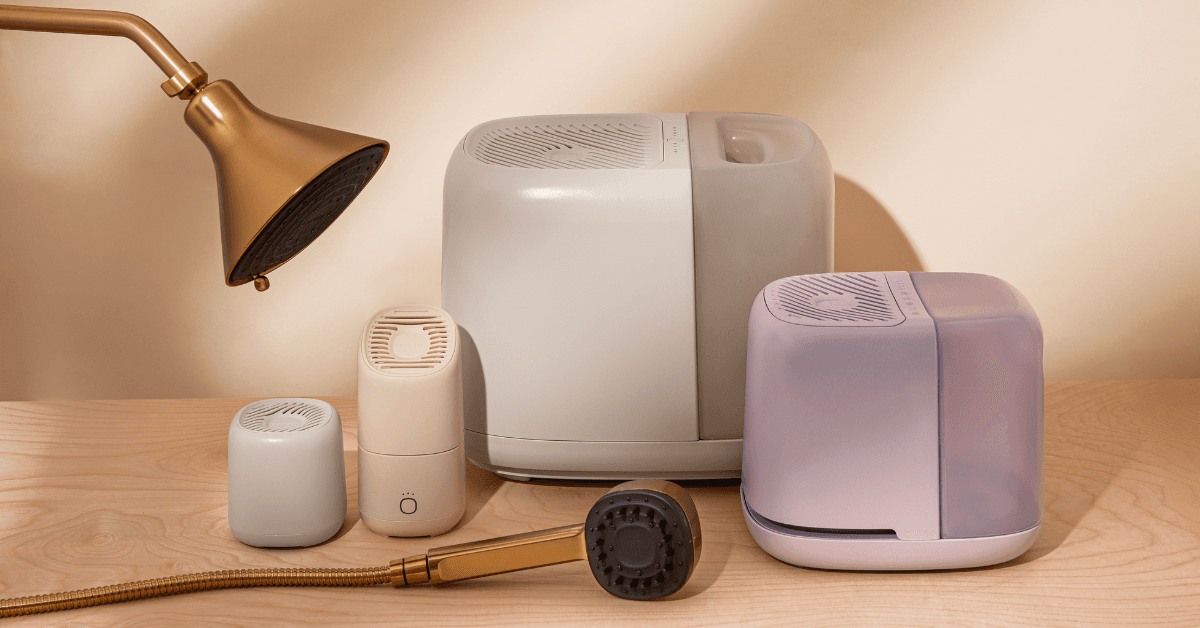 Canopy humidifiers, filtered showerheads, and aroma diffusers arranged on a wood surface