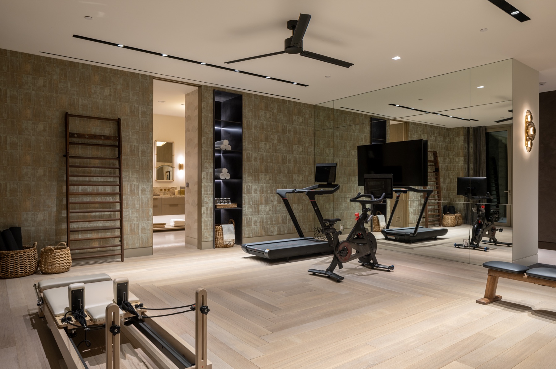Cardio equipment and mirror wall in the lower-level gym at 3512 Ocean Boulevard
