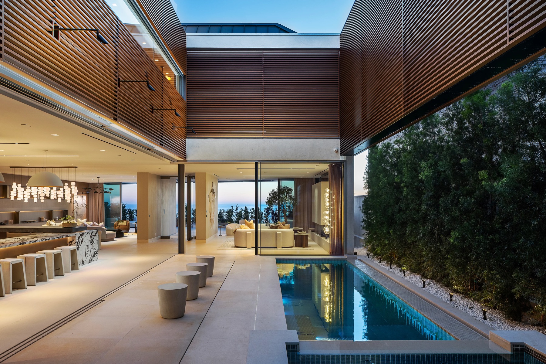 Interior pool courtyard at 3512 Ocean Boulevard with main level kitchen and lounge areas opening to the pool