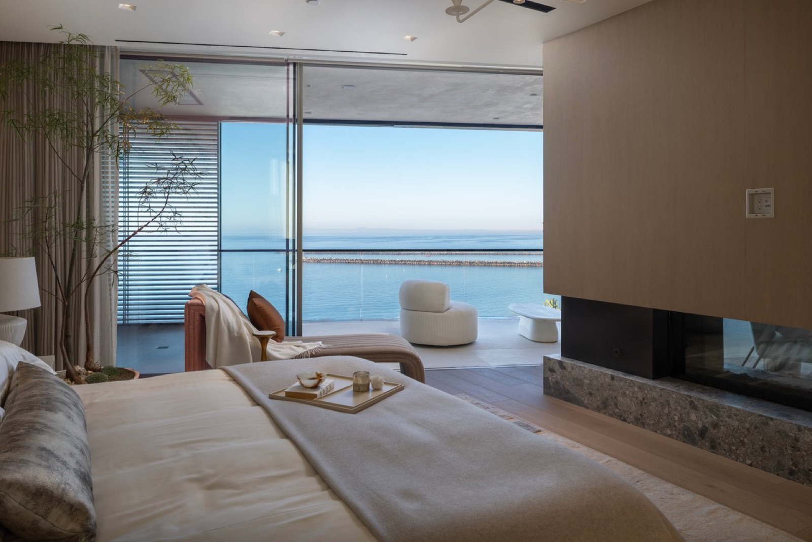 Primary suite fireplace and balcony view at 3512 Ocean Boulevard