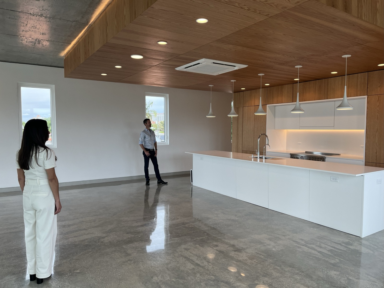 Nathalie Manzano and Ted Caplow standing in CM1's great room near the kitchen island before furnishing