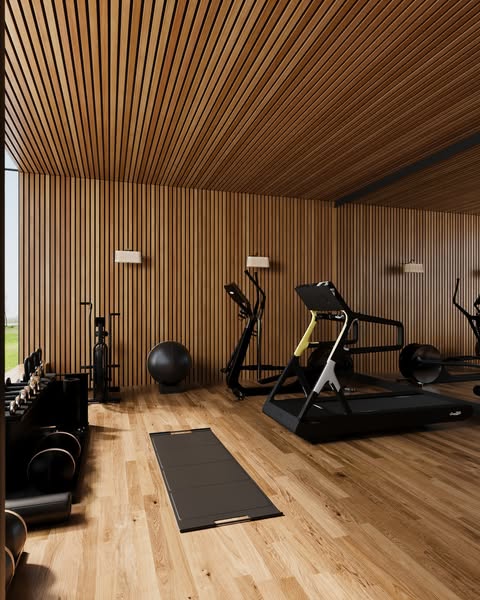 Oak-slatted gym with a Technogym treadmill, dumbbells, and medicine ball under a vaulted timber ceiling